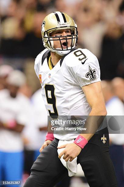 Quarterback Drew Brees of the New Orleans Saints celebrates his record breaking first quarter touchdown pass against the San Diego Chargers at...