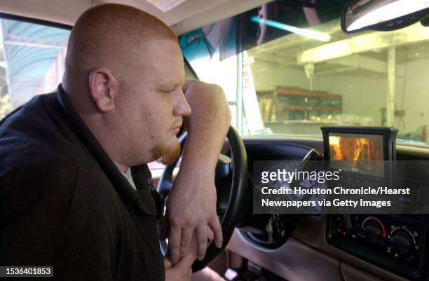 Automobile Accessories: 8/5/04-Allan Strode, an accessory installer at Ochterbeck, checks out a DVD player that he installed in an SUV. DVD players...
