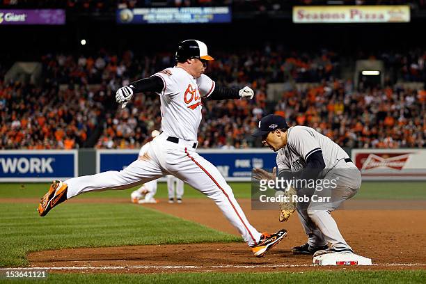 Mark Teixeira of the New York Yankees catches the ball to force out Lew Ford of the Baltimore Orioles in the bottom of the fifth inning during Game...