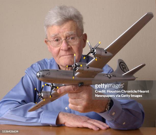 Paul W. Tibbets was the pilot of the B-29 Enola Gay that dropped the atomic bomb on Hiroshima at the end of World War II. He is holding a replica of...