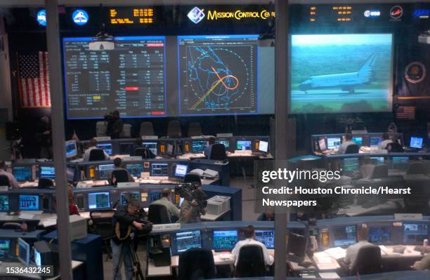 Mission control monitors Discovery crew members as they rehearse launch and landing simulations in a Shuttle Simulator. Photo by Steve Campbell