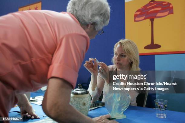 Reyne Haines talks with Jacqueline Dempsey about items that Dempsey brought to the Antiques Roadshow at the Reliant Center. Antiques Roadshow, PBS's...