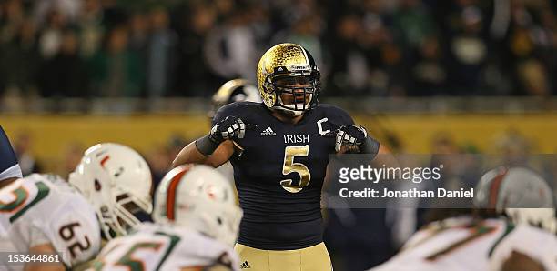 Manti Te'o of the Notre Dame Fighting Irish calls defensive signals against the Miami Hurricanes at Soldier Field on October 6, 2012 in Chicago,...