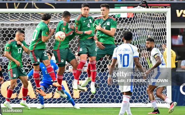 Mexico players jump to block a shoot on goal during the Concacaf 2023 Gold Cup final football match between Mexico and Panama at SoFi Stadium in...