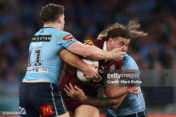 Patrick Carrigan of the Maroons is tackled during game three of the State of Origin series between New South Wales Blues and Queensland Maroons at...