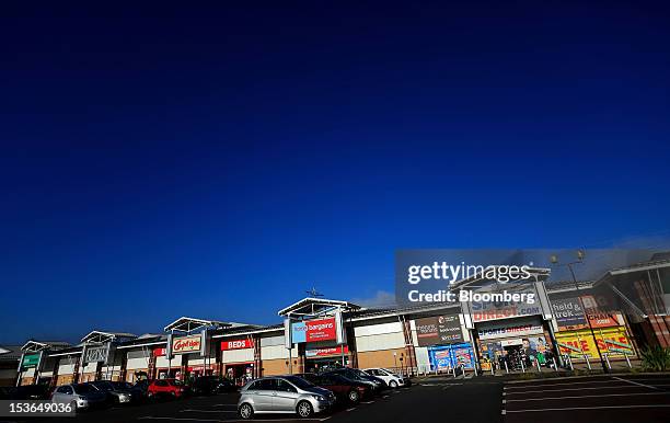 Sports Direct International Plc store, right, stands amongst other stores in a retail park in Urmston, U.K., on Saturday, Oct. 6, 2012. JJB Sports...