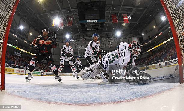 Andre Reiss of Hannover scores his team's 2nd goal over Patrick Ehelechner , goaltender of Augsburg during the DEL match between Hannover Scorpions...