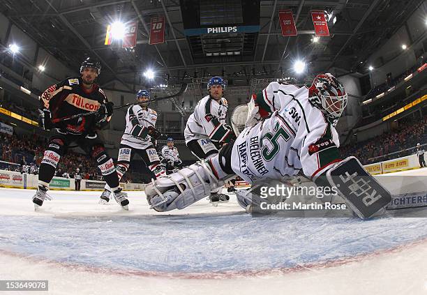 Andre Reiss of Hannover scores his team's 2nd goal over Patrick Ehelechner , goaltender of Augsburg during the DEL match between Hannover Scorpions...