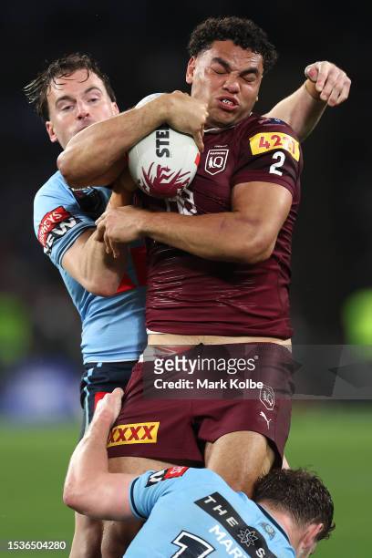 Xavier Coates of the Maroons is tackled by Clinton Gutherson of the Blues during game three of the State of Origin series between New South Wales...