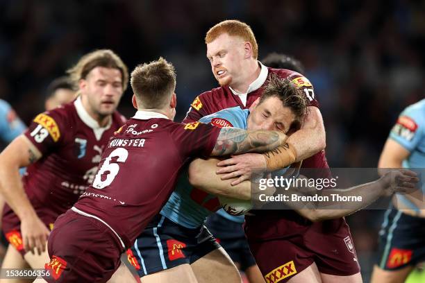 Cameron Murray of the Blues is tackled by Cameron Munster and Corey Horsburgh of the Maroons during game three of the State of Origin series between...