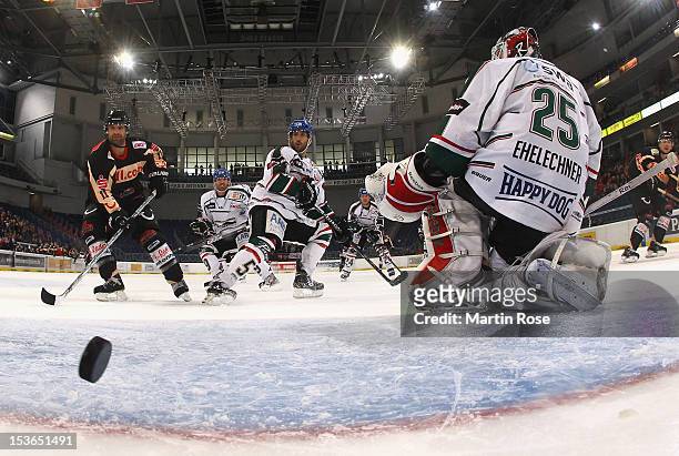 Andreas Morczinietz of Hannover scores his team's 1st goal over Patrick Ehelechner , goaltender of Augsburg during the DEL match between Hannover...