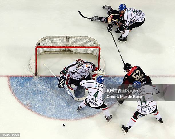 Sachar Blank of Hannover fails to score over Patrick Ehelechner , goaltender of Augsburg during the DEL match between Hannover Scorpions and...