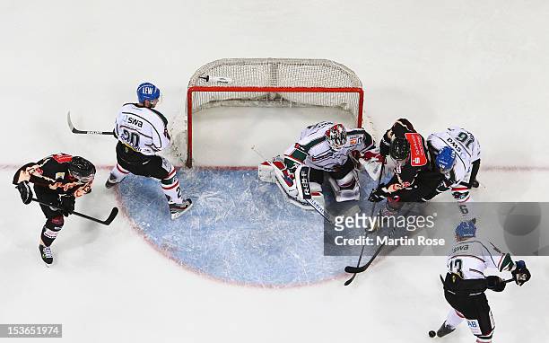 Andre Reiss of Hannover fails to score over Patrick Ehelechner , goaltender of Augsburg during the DEL match between Hannover Scorpions and...