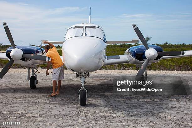 Pilot is checking a Piper, a private charter aircraft at Cat Island Airport on June 15, 2012 in Cat Island, The Bahamas.