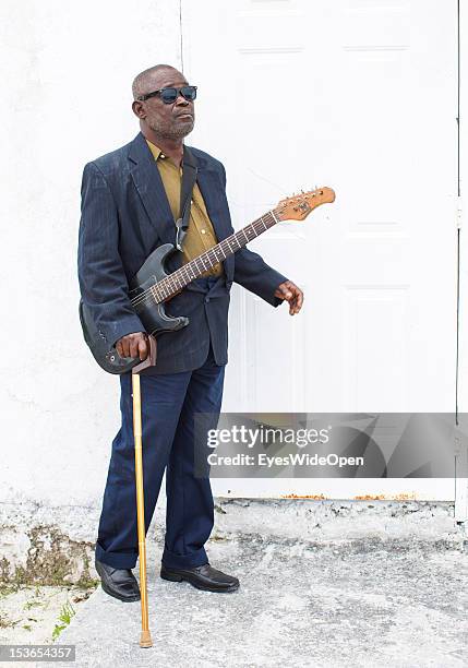 Portrait of a local bahamian old and blind man, a guitar player who performs at the sunday service in the Zion Baptist Church in Old Bight on June...