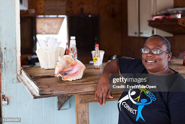 Portrait of a local bahamian woman at a foodstall at New Bight Beach on June 15, 2012 in Cat Island, The Bahamas.
