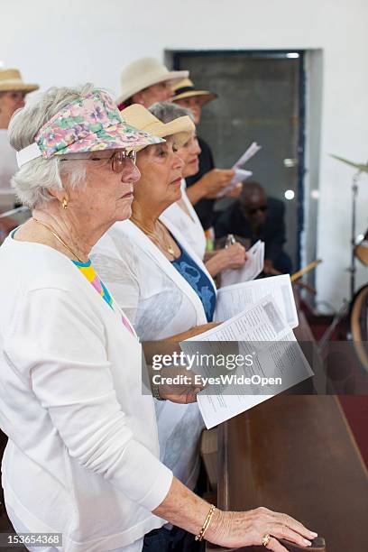 Old american ladies, tourists, are attending and singing at the sunday service in the Zion Baptist Church in Old Bight on June 15, 2012 in Cat...