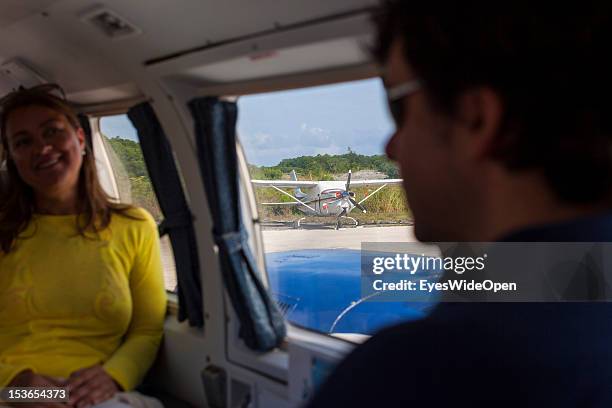 Tourists are sitting in a Piper, a private charter aircraft at Cat Island Airport on June 15, 2012 in Cat Island, The Bahamas.