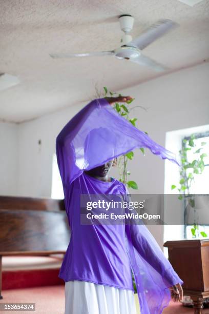 Local bahamian young girl is dancing the angel dance at the sunday service in the Zion Baptist Church in Old Bight on June 15, 2012 in Cat Island,...