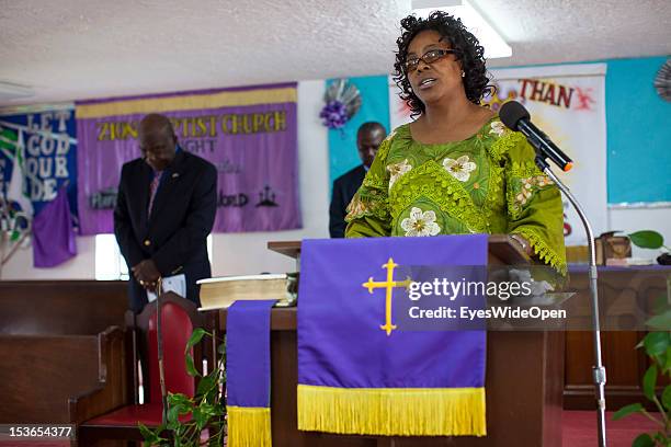 Local bahamian lady is praying at the sunday service in the Zion Baptist Church in Old Bight on June 15, 2012 in Cat Island, The Bahamas.