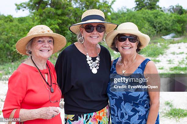 Portrait of three old american ladies, senior tourists, with straw hats in Old Bight on June 15, 2012 in Cat Island, The Bahamas.