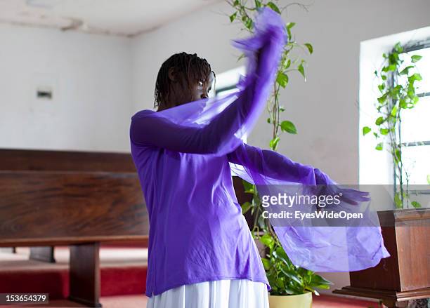 Local bahamian young girl is dancing the angel dance at the sunday service in the Zion Baptist Church in Old Bight on June 15, 2012 in Cat Island,...