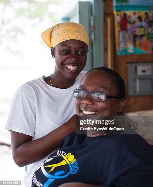 Portrait of a local bahamian business woman with her daughter at their foodstall at New Bight Beach on June 15, 2012 in Cat Island, The Bahamas.