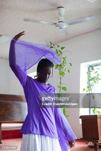 Local bahamian young girl is dancing the angel dance at the sunday service in the Zion Baptist Church in Old Bight on June 15, 2012 in Cat Island,...