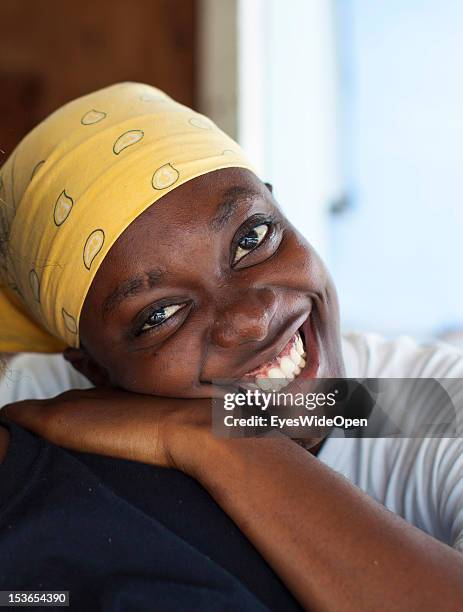 Portrait of a local bahamian young woman who is smiling at her foodstall at New Bight Beach on June 15, 2012 in Cat Island, The Bahamas.