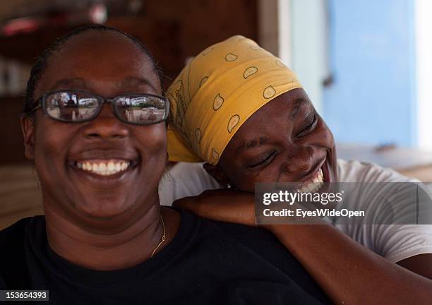 Portrait of a local bahamian woman and mother with her daughter at their foodstall at New Bight Beach on June 15, 2012 in Cat Island, The Bahamas.