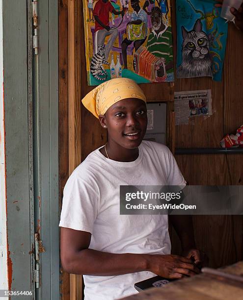 Britney, a young local bahamian lady, at her foodstall at New Bight Beach on June 15, 2012 in Cat Island, The Bahamas.