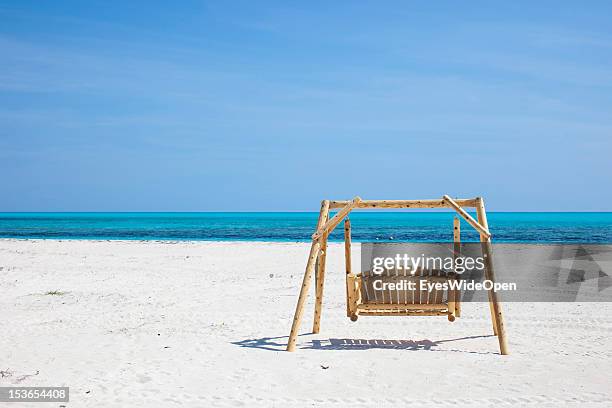 Carribean feeling - a lonely hollywood swing in the white sands of Shannas Cove Beach and the carribean sea on June 15, 2012 in Cat Island, The...