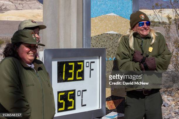 Park Ranger Eric Henson pretends to be cold while posing next to the unofficial thermometer at the Furnace Creek Visitor Center indicating a...