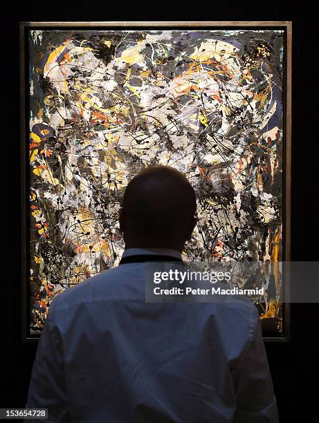 Sotheby's employee stands in front of Jackson Pollock's 'Number 4, 1951' on October 8, 2012 in London, England. Estimated at $25-35 million the work...