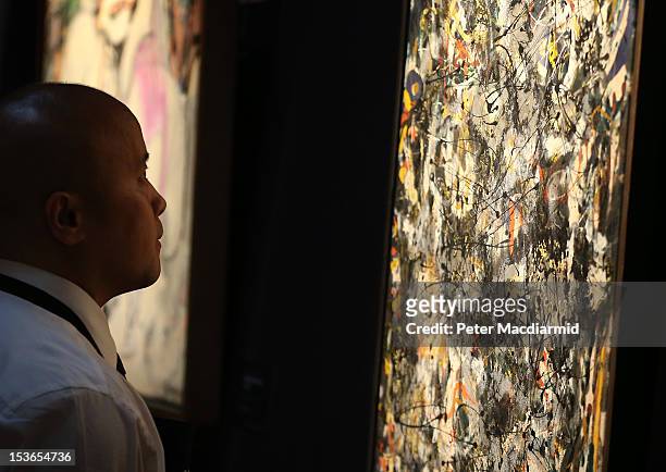 Sotheby's employee stands in front of Jackson Pollock's 'Number 4, 1951' on October 8, 2012 in London, England. Estimated at $25-35 million the work...