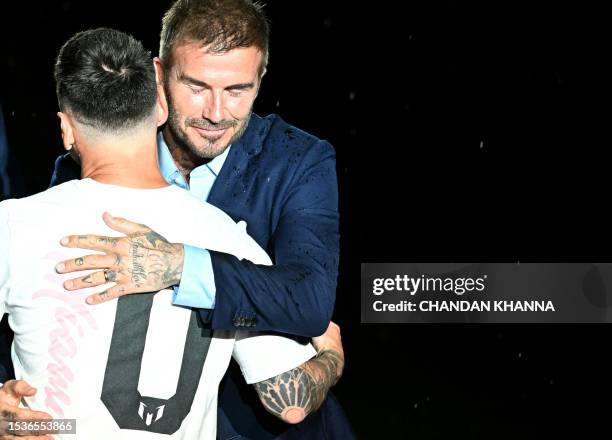 Argentine soccer star Lionel Messi hugs former British football player and one of the owners of Inter Miami CF David Beckham as he is presented as...