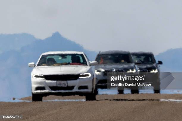 Cars shimmer in the heat haze as the temperature rises past about 127 degrees Fahrenheit on a day that could set a new world heat record in Death...