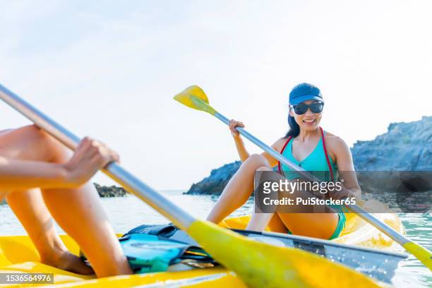 asian athletic woman together with friend on kayak and take a photo. outdoor water sport and travel on summer holiday thailand. - ko lipe stock pictures, royalty-free photos & images