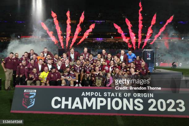 Queensland players and support staff celebrate victory following game three of the State of Origin series between New South Wales Blues and...
