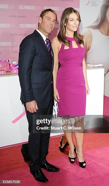 Shane Warne and Elizabeth Hurley attend a Photocall for Estee Lauder during Breast Cancer Awareness Month at Selfridges on October 8, 2012 in London,...