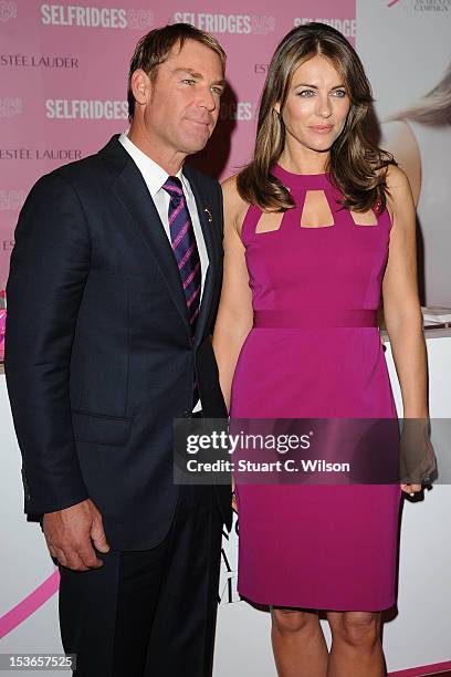 Shane Warne and Elizabeth Hurley attend a Photocall for Estee Lauder during Breast Cancer Awareness Month at Selfridges on October 8, 2012 in London,...