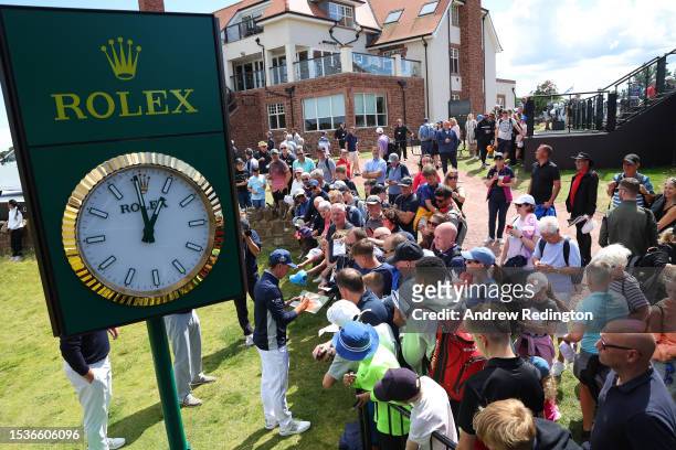 Rickie Fowler of the United States signs autographs for fans after finishing his round during the Pro-Am prior to the Genesis Scottish Open at The...