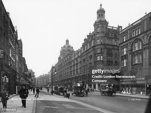 View down Brompton Road in Knightsbridge, London, with the Harrods department store on the right, circa 1910. The building, designed by architect...