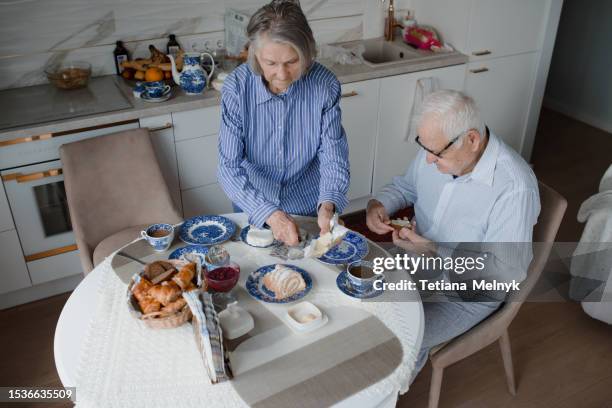 quiet life in old age, there is happiness. grandfather stands at the window waiting - granny flat stock pictures, royalty-free photos & images