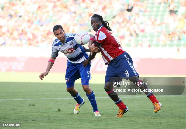 Blas Perez of FC Dallas and Shalrie Joseph of Chivas USA vie for the ball in the first half during the MLS match at The Home Depot Center on October...