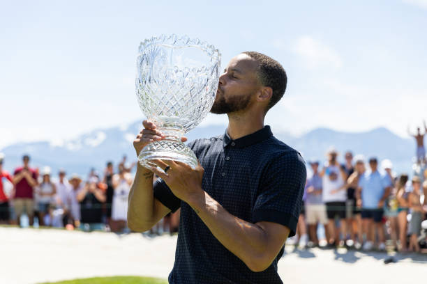 Stephen Curry of the NBA Golden State Warriors kisses his trophy after winning the championship on Day Three of the 2023 American Century...