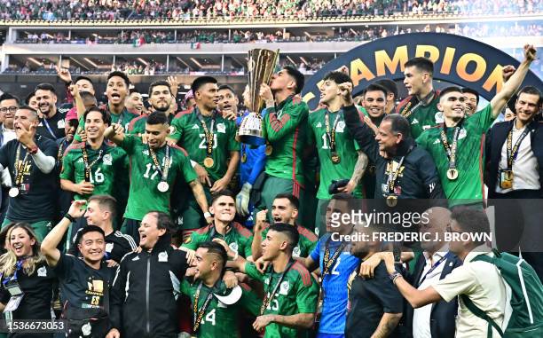 Mexico's midfielder Edson Alvarez kisses the Concacaf Gold Cup after Mexico won the final football match against Panama at SoFi Stadium in Inglewood,...