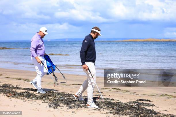 Dan Bradbury of England and Joost Luiten of Netherlands take part in a beach clean prior to the Genesis Scottish Open at The Renaissance Club on July...