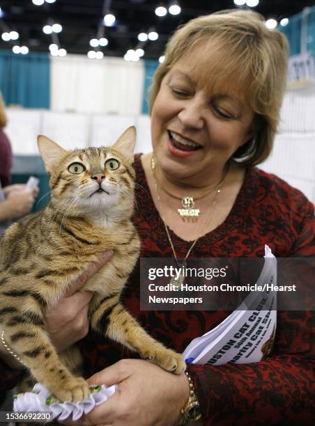 Karen Godwin from Baton Rouge, LA holds "Mo", her Egyptian Mau cat at the Houston Cat Club's 56th Annual Charity Cat Show at the George R. Brown...