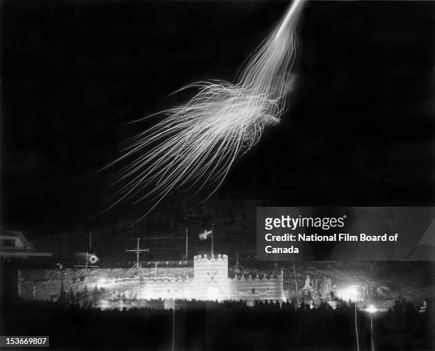 Fireworks illuminate the sky over the carnival's ice castle located at the foot of the ski mountain of Sainte-Agathe-des-Monts, the Laurentians,...
